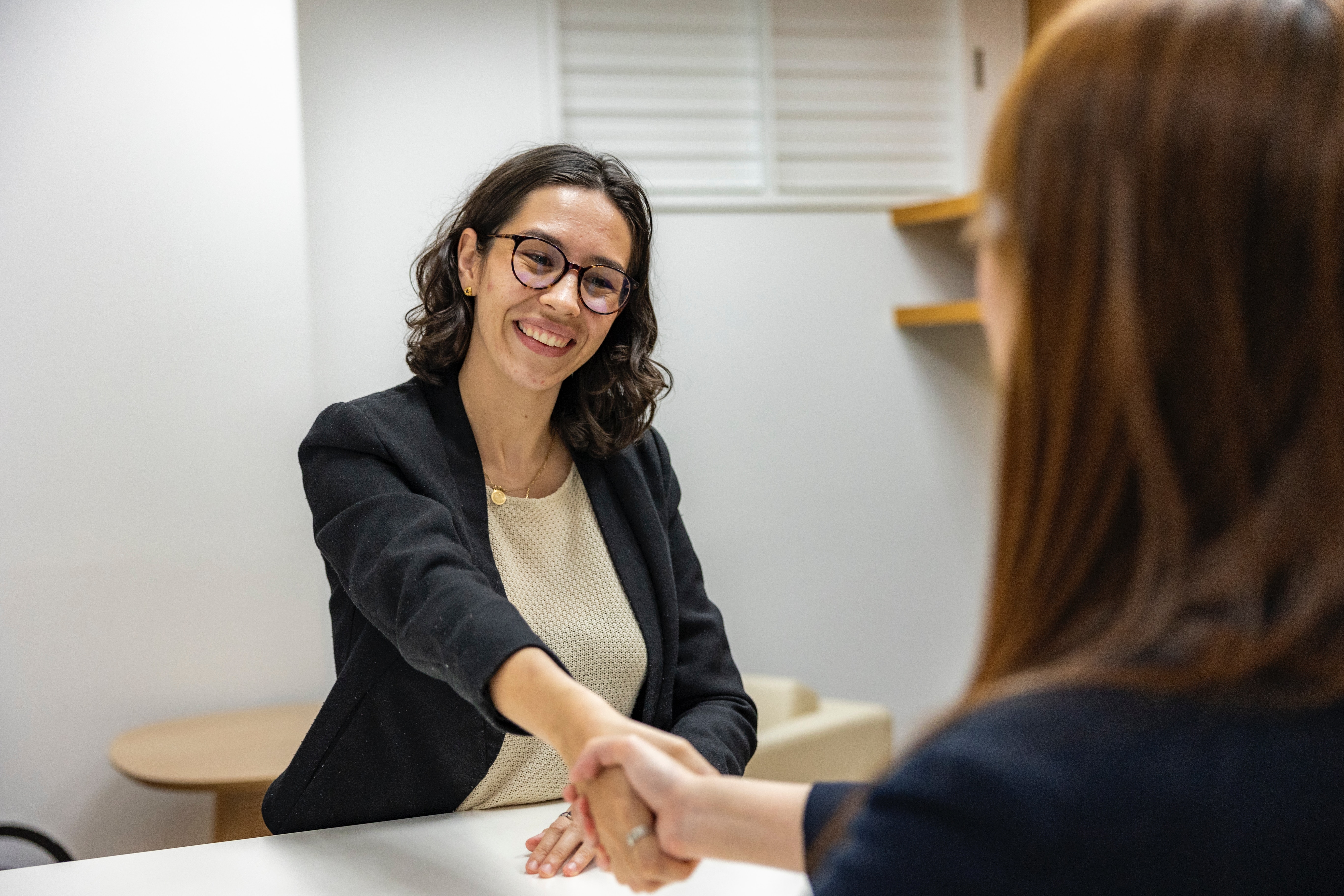 Woman shaking recruiter managers hand