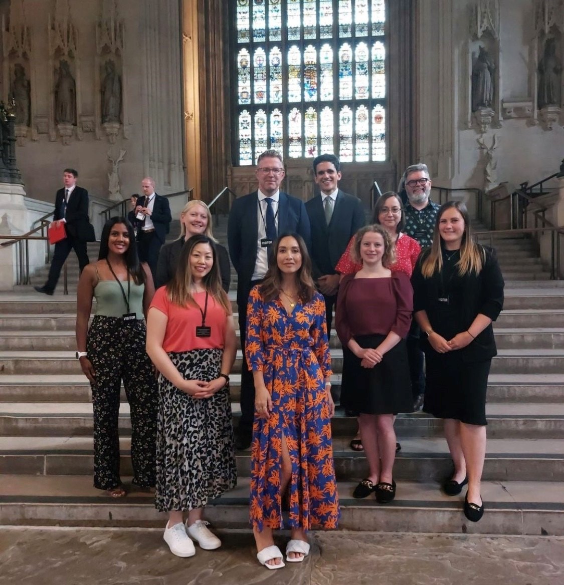 A group of people dressed smartly stood on steps
