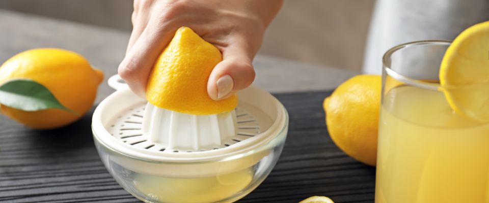Person squeezing juice from lemon