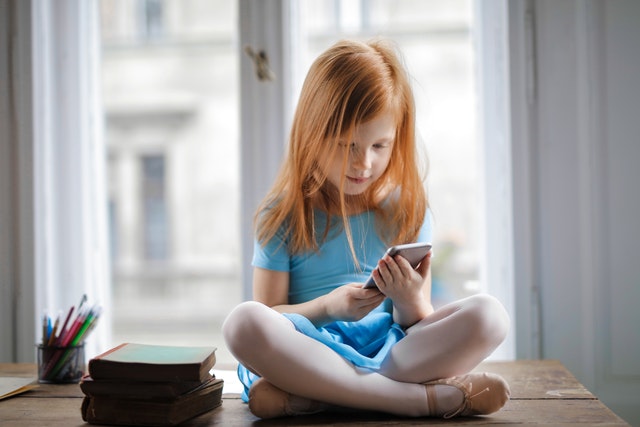 Child playing an app on a mobile device