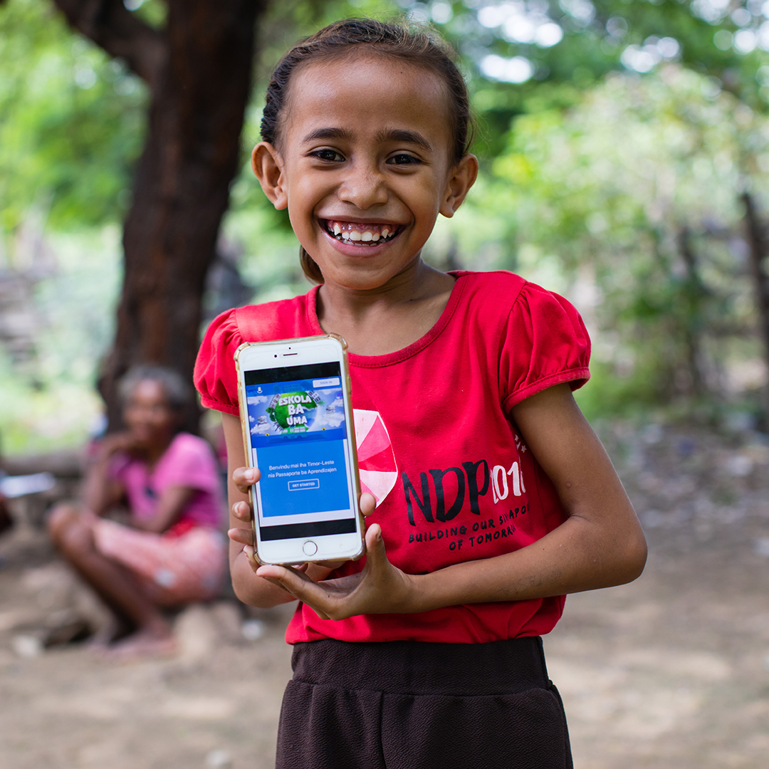 On 14 April 2020, a girl shows off the online platform on which children and parents in Timor-Leste can access a range of audio-visual material to help students continue learning during ongoing school closures.