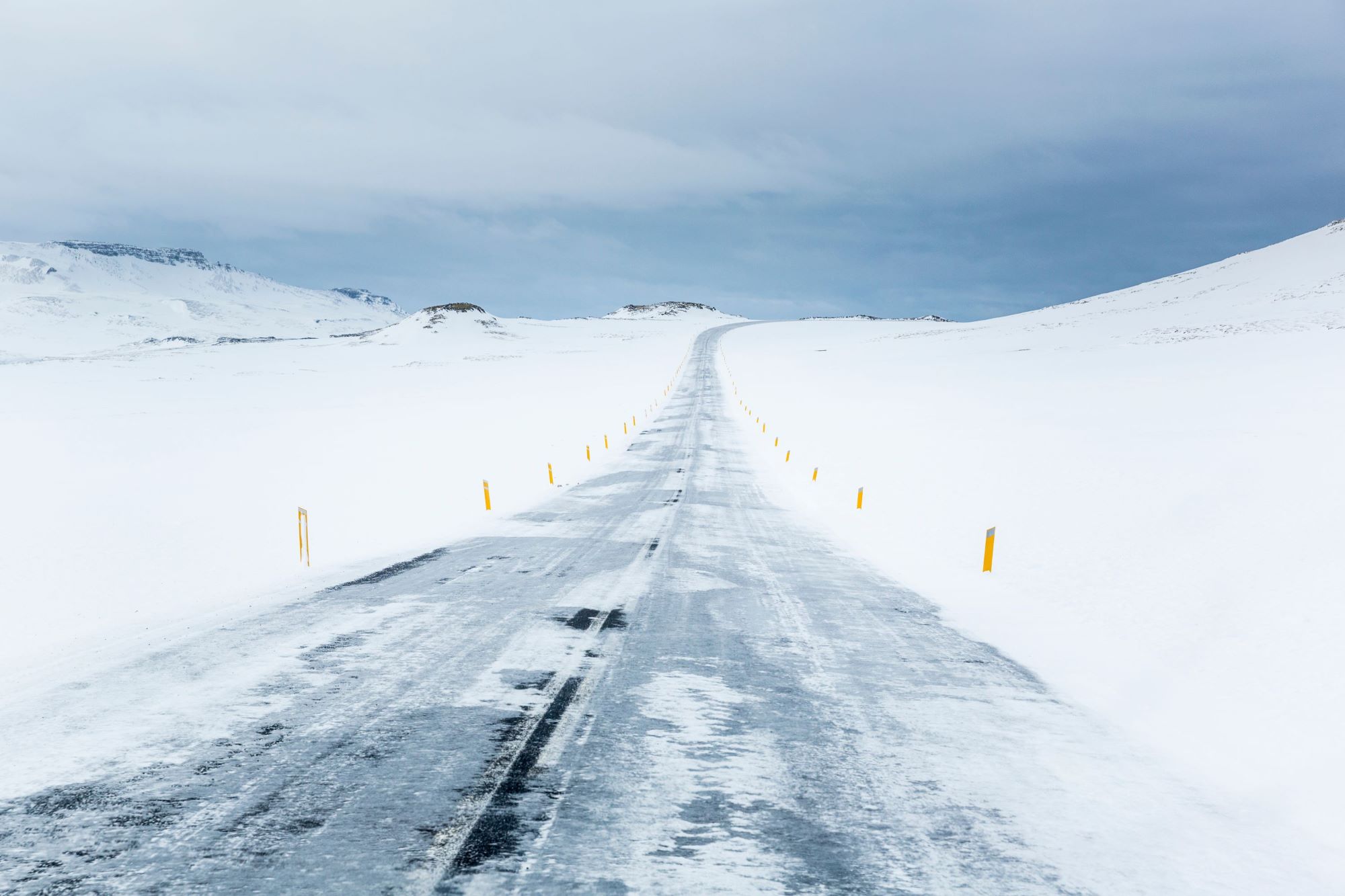 Icy roads leading through snowy landscapes in winter