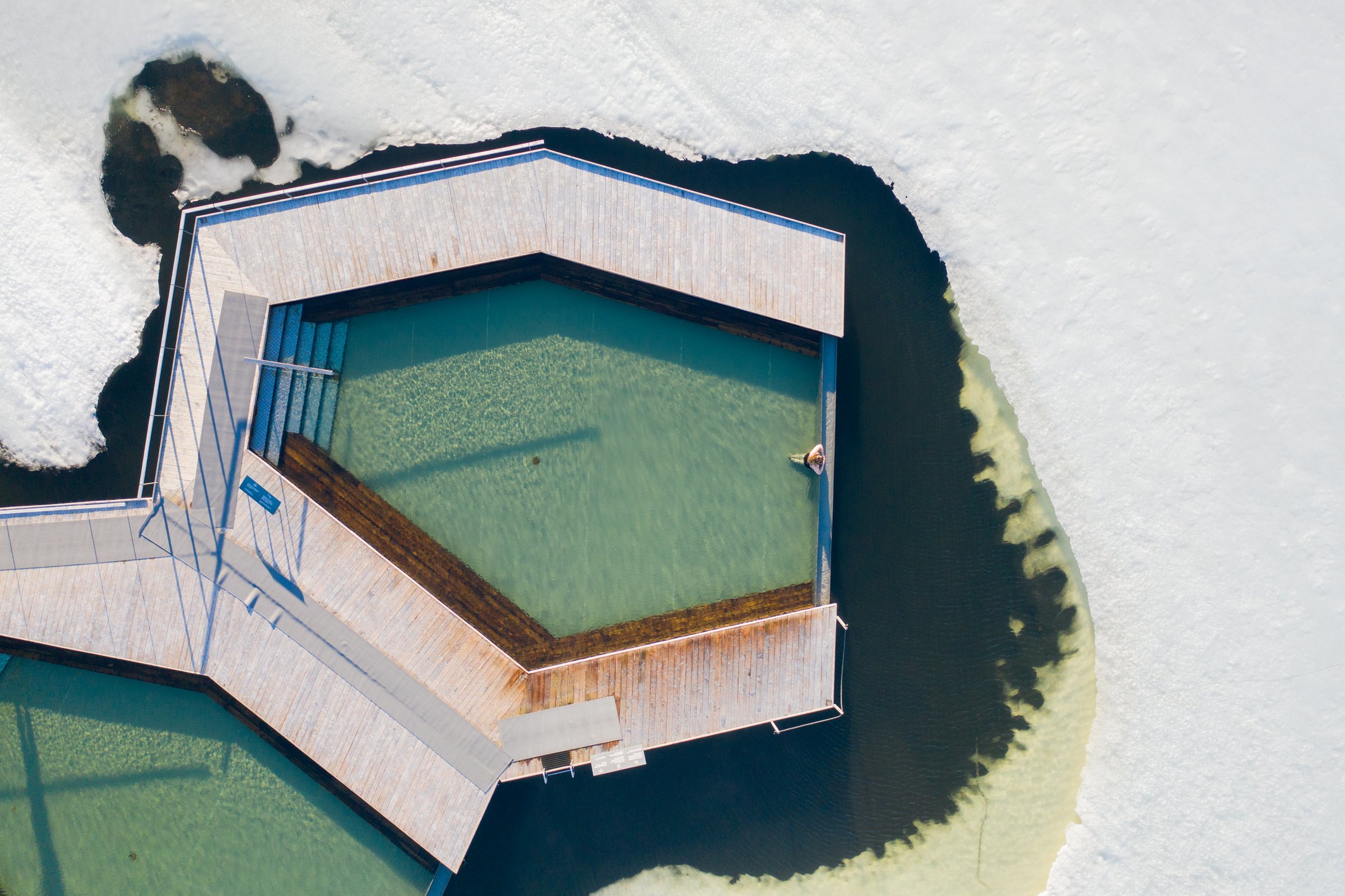 Aerial view of one pool at Vök baths in a frozen lake