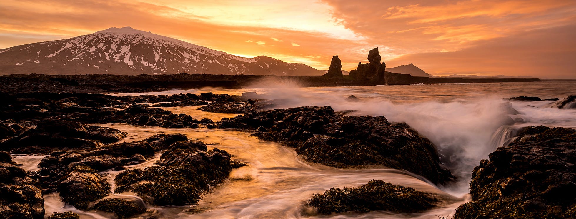 Snaefellsjokull volcano, londrangar sea stacks and the waves on the rugged shoreline
