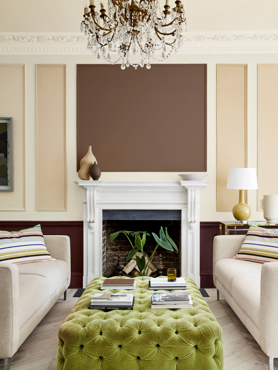 Sitting room with a natural beige (Clay - Mid) wall and paneling in deep stone, pale brown and fawn colours, and two sofas.