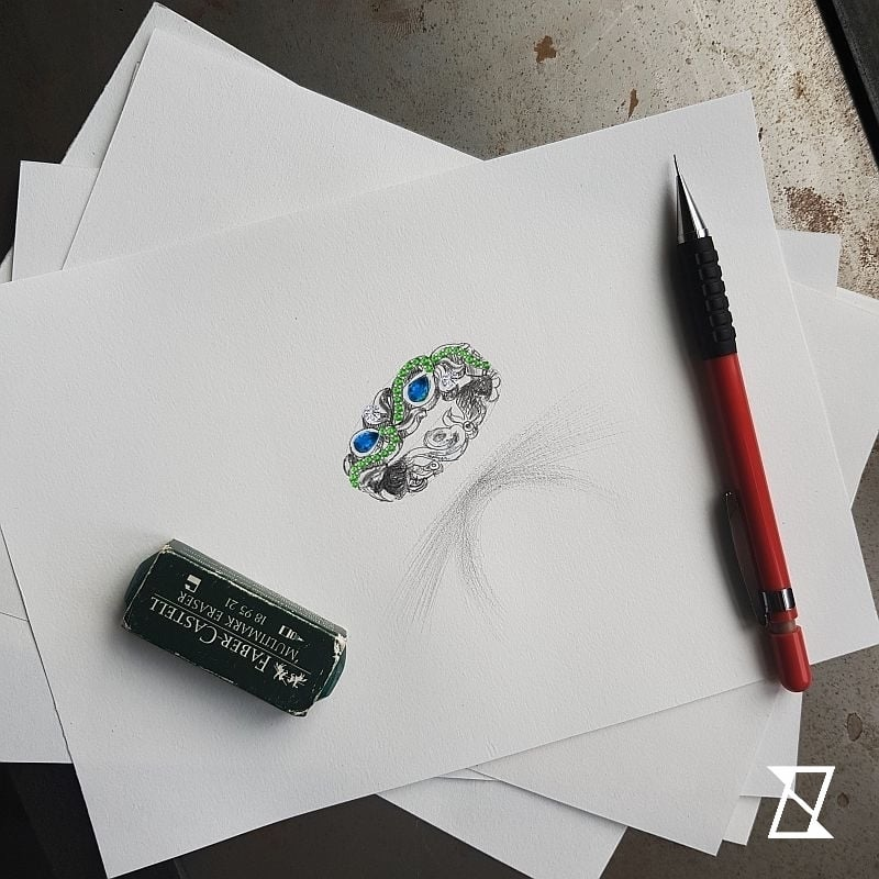 Bespoke design of a wedding ring with tsavorites, sapphires and diamonds.